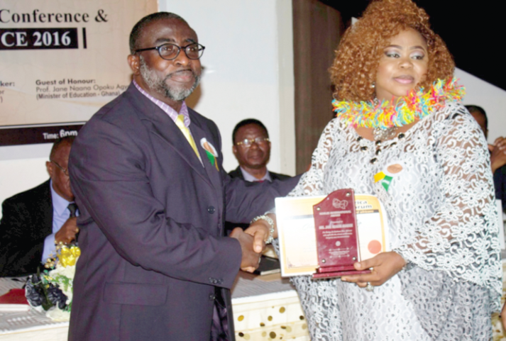 Noble Mrs Jane R. Ahadzi receiving her award from the Vice Chancellor of Wisconsin International University College, Dr Carlos Arrow